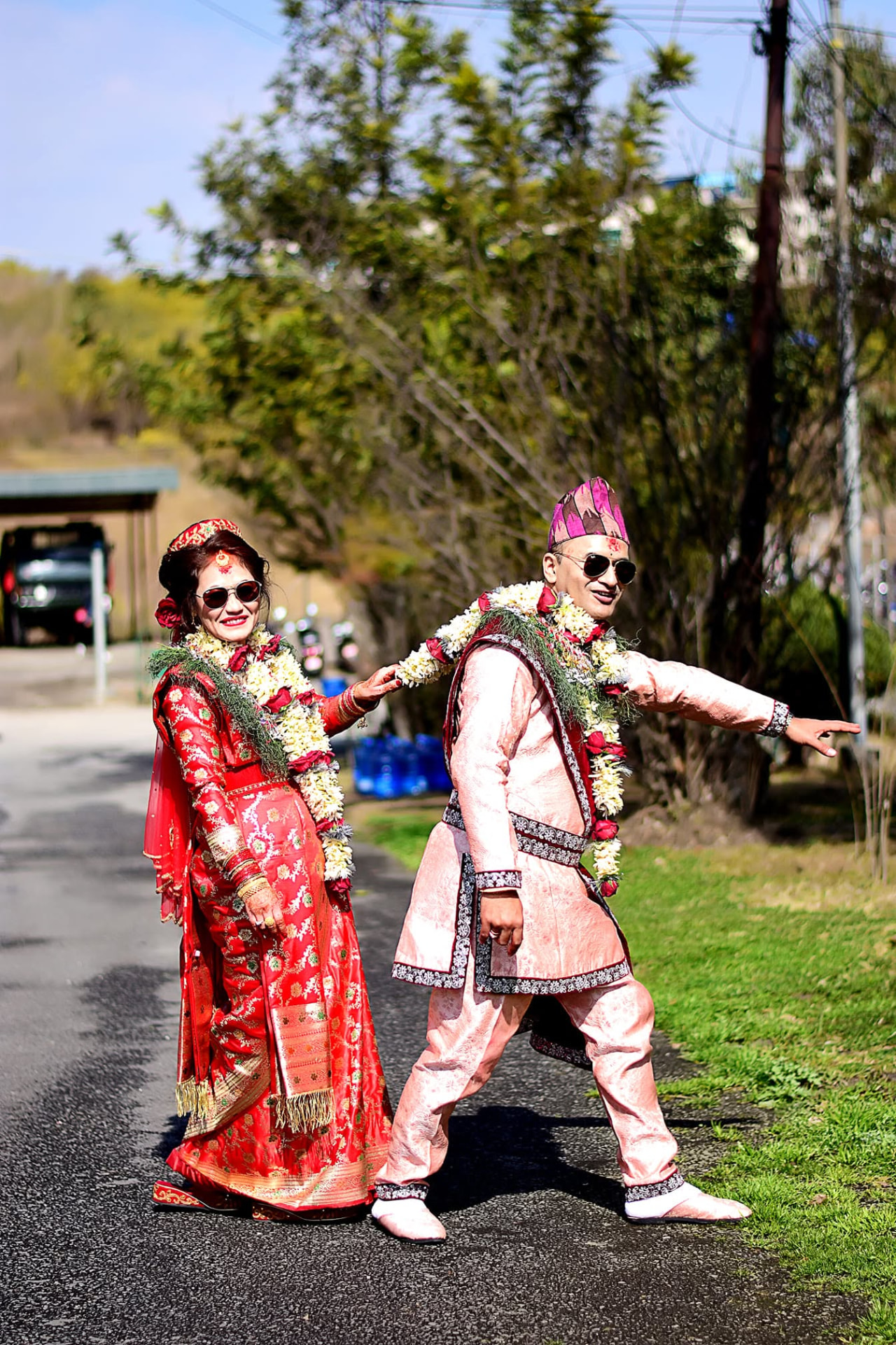 Couple in traditional attire posing outdoors